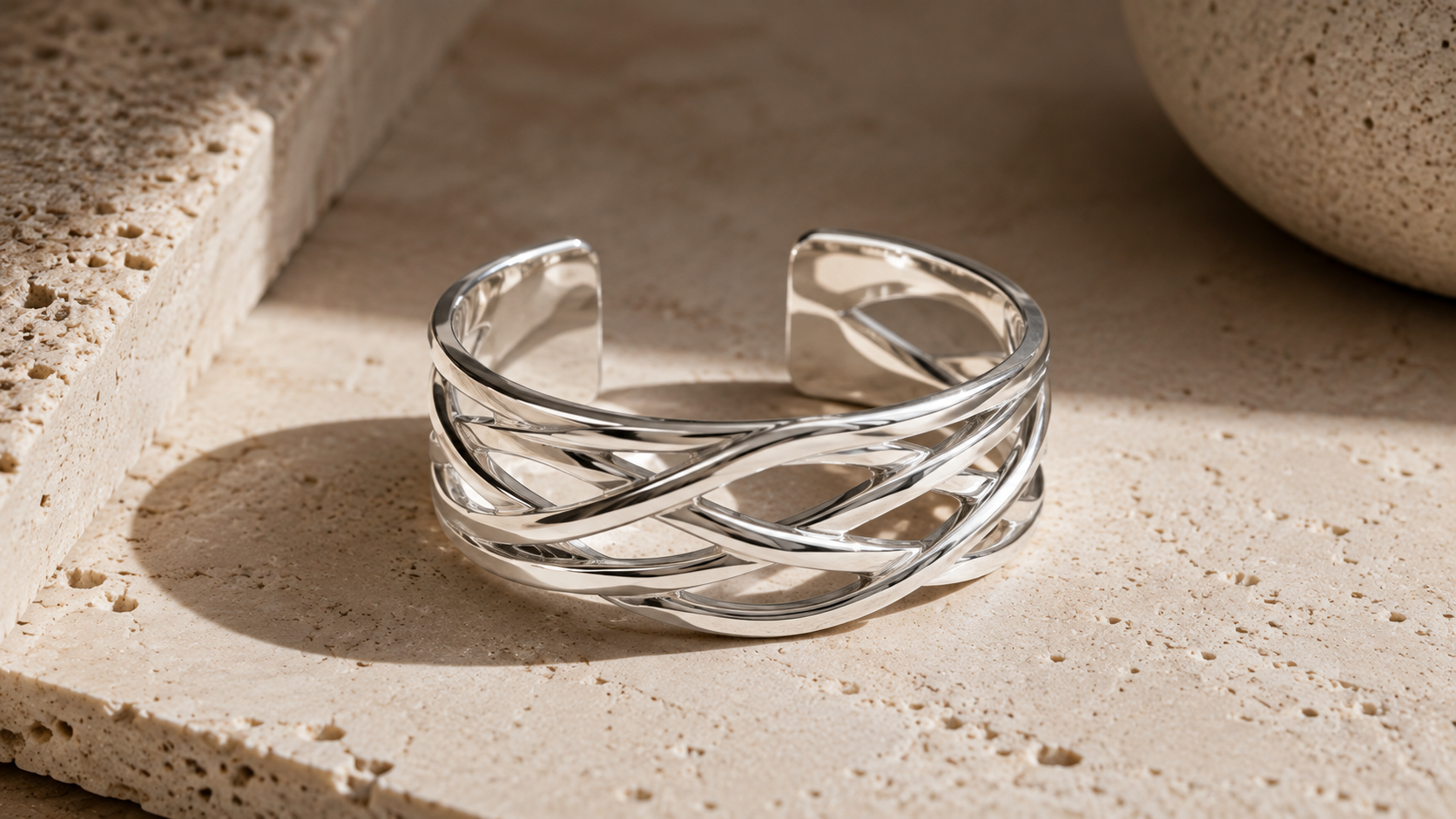 VY Jewelry sponsored campaign — open-weave sterling silver cuff photographed in sunlight on stone