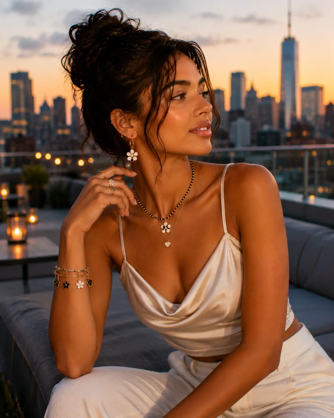 Woman in a champagne satin slip top with beaded bracelets at sunset