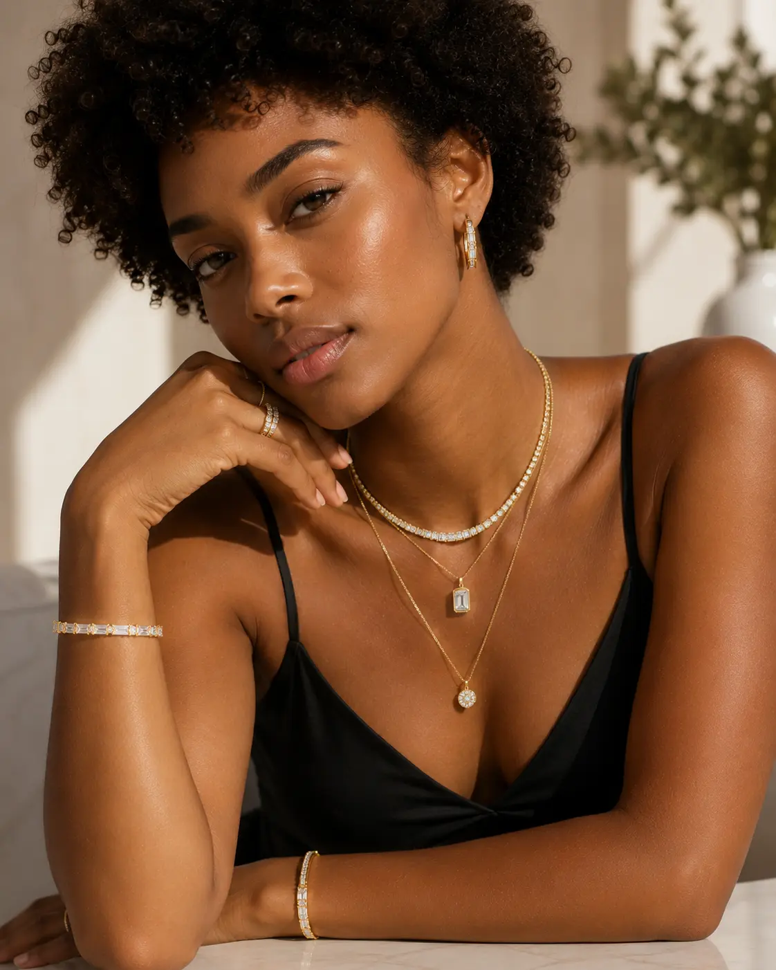 Woman wearing layered gold necklaces and a bracelet