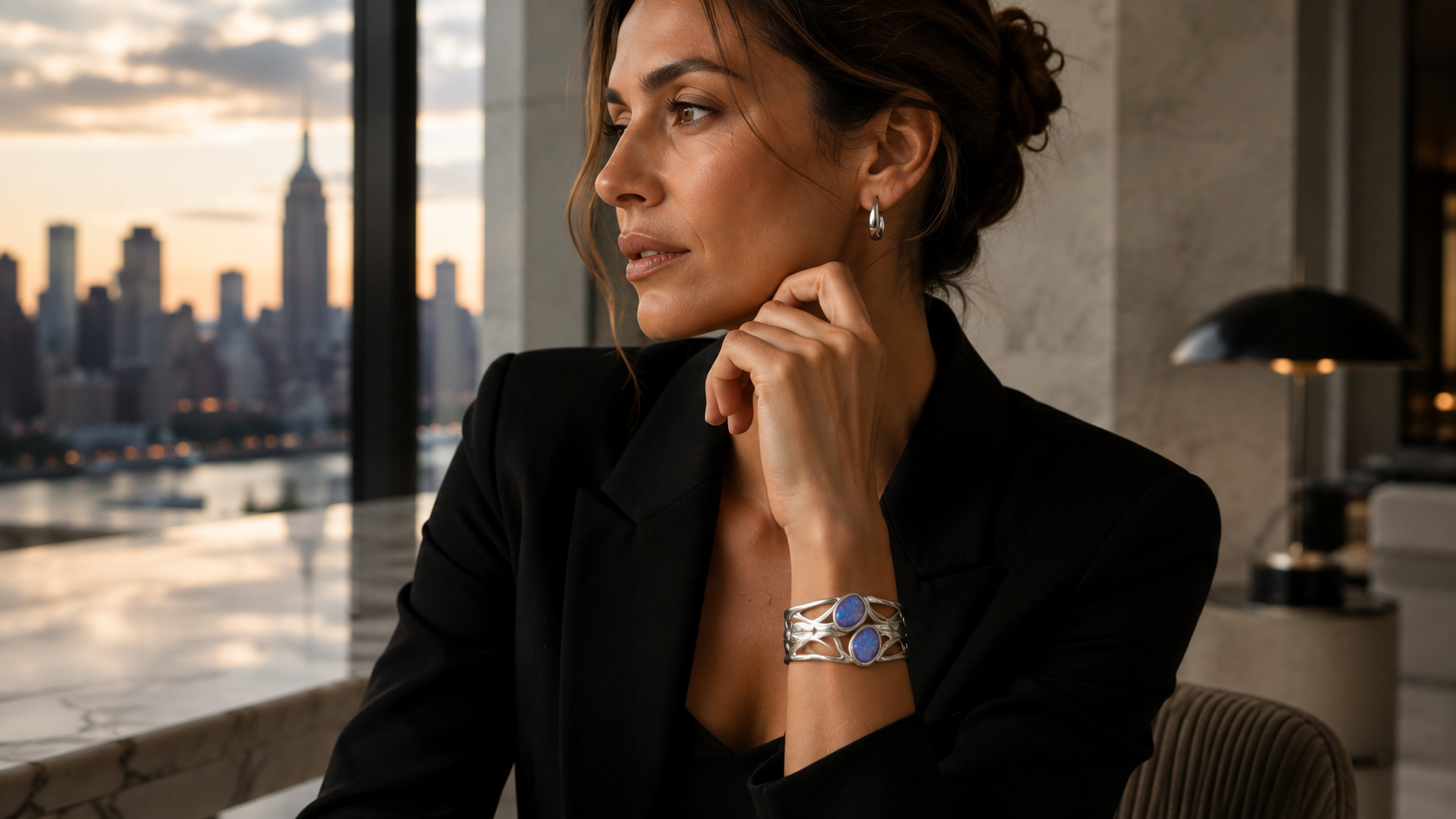 VY Jewelry sponsored campaign — model in a black blazer wearing the blue opal silver cuff and silver hoops at golden hour