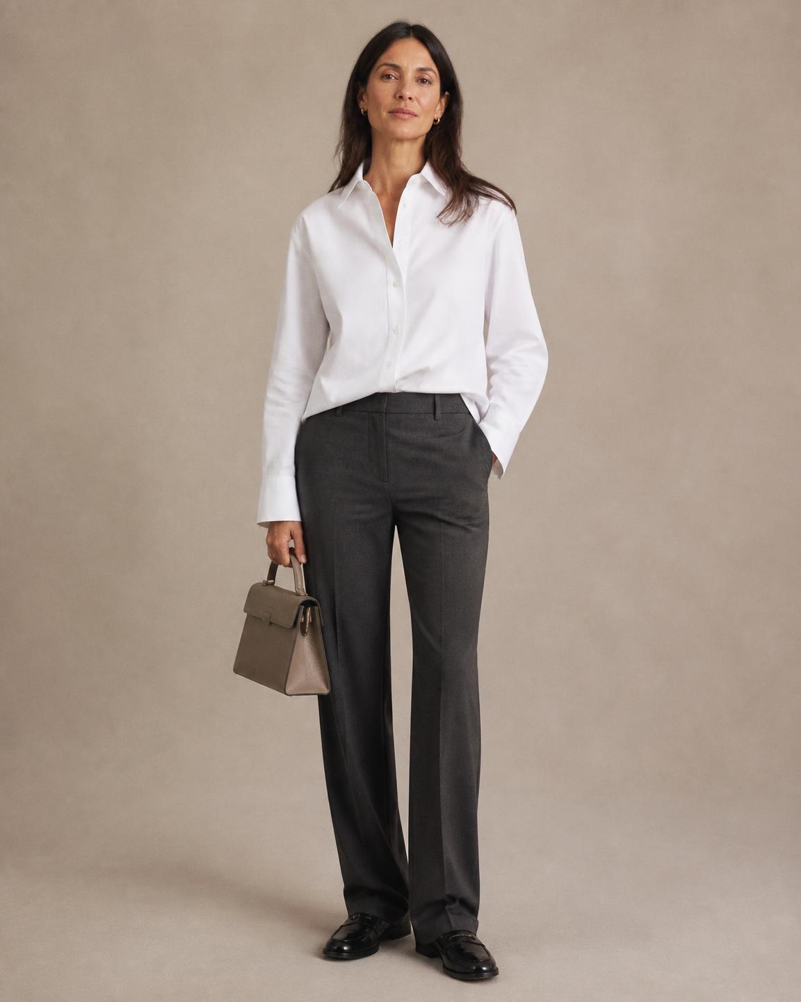 Styled look: white poplin shirt, black wide trousers and a small structured bag